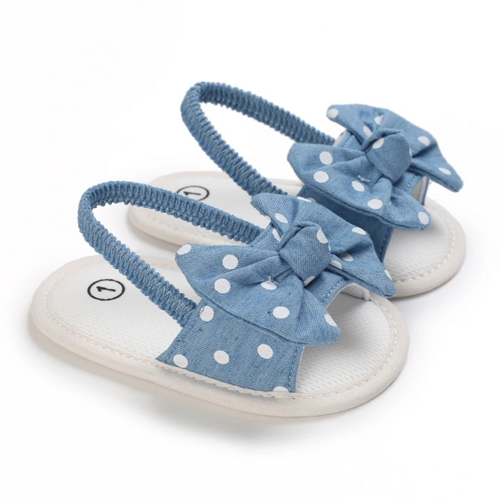 Blue baby sandals with white polka-dot bows and white footbeds