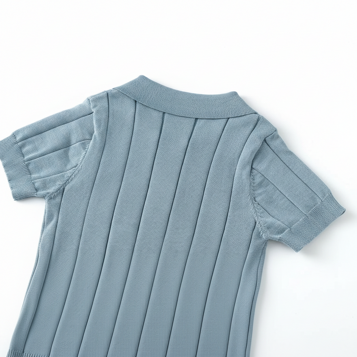 Back shoulder and collar of the blue polo shirt with vertical knit lines