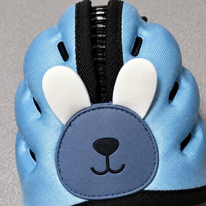 Blue rabbit headguard showing ear appliques and openings along the top
