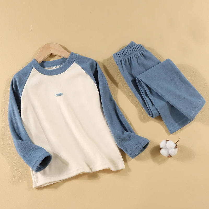 Blue pajama set with a cream-front raglan top and matching elastic-waist pants.