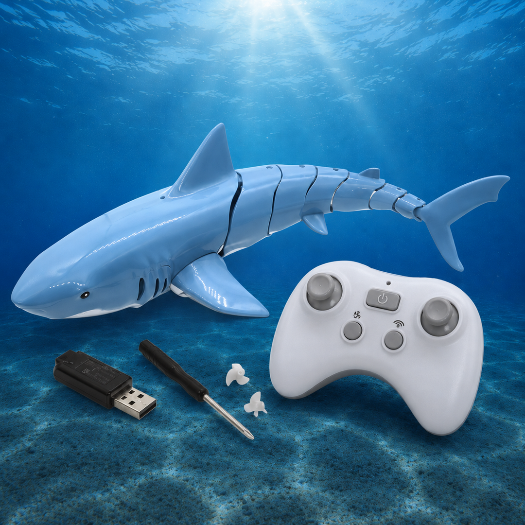 Blue RC shark beside its remote, USB charger, screwdriver and propellers