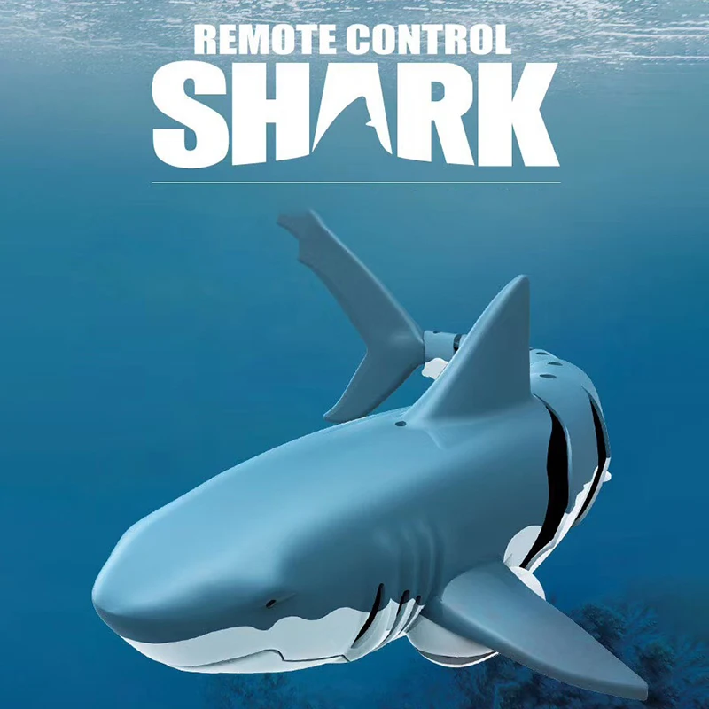 Blue RC shark with a white underside against an underwater background