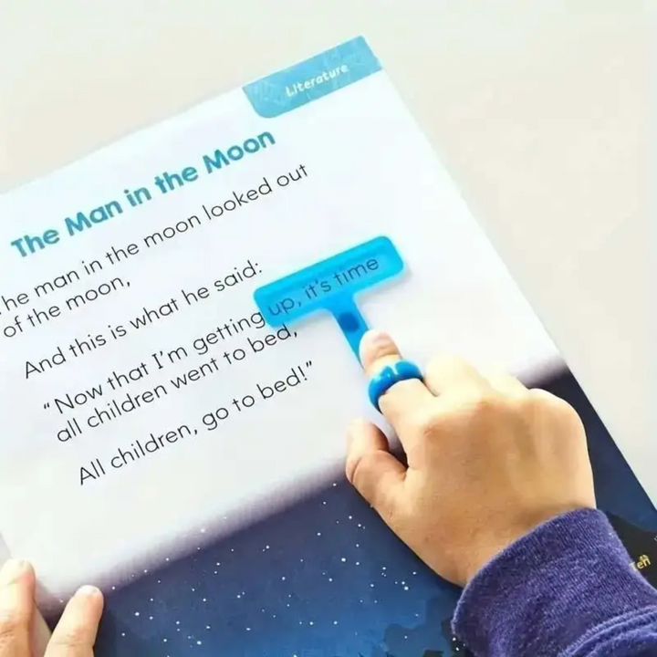 Blue finger-worn reading guide highlighting a line in a children&