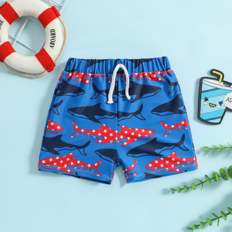 Blue swim trunks with red and navy shark prints and a white drawstring, laid flat