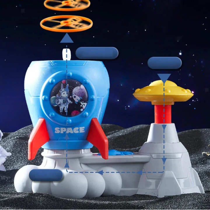 Blue rocket-shaped disc launcher with a yellow foot pedal and orange flying discs