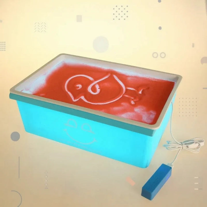 Blue sand drawing board with a white outline drawing on a red-lit surface