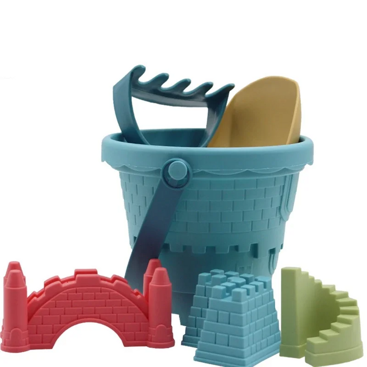 Blue sandcastle bucket with a yellow scoop, blue rake, and three colorful sand molds
