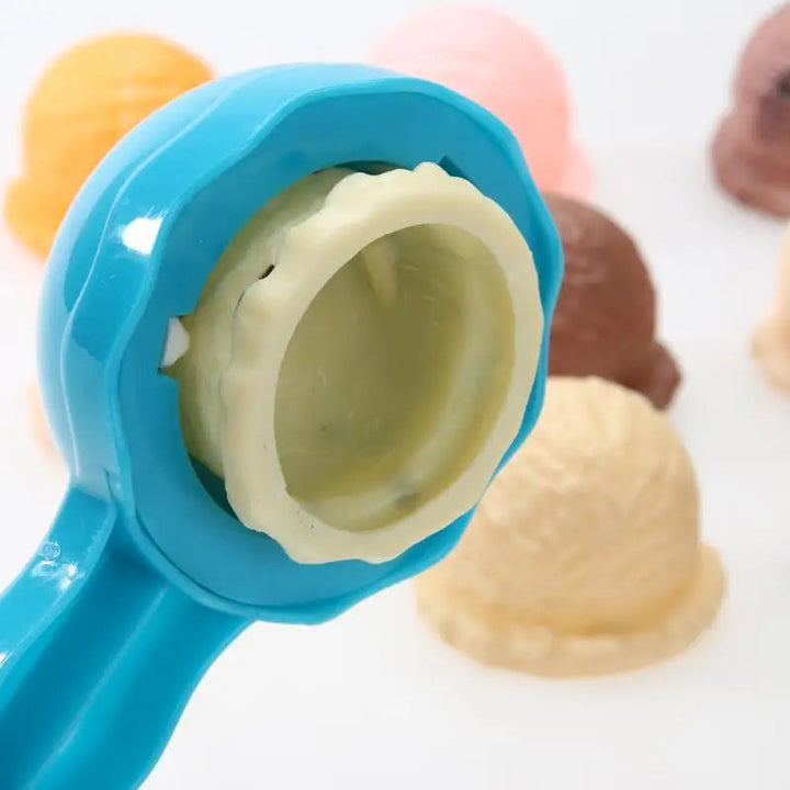 Close-up of a blue scoop holding an ice cream piece with a hollow underside