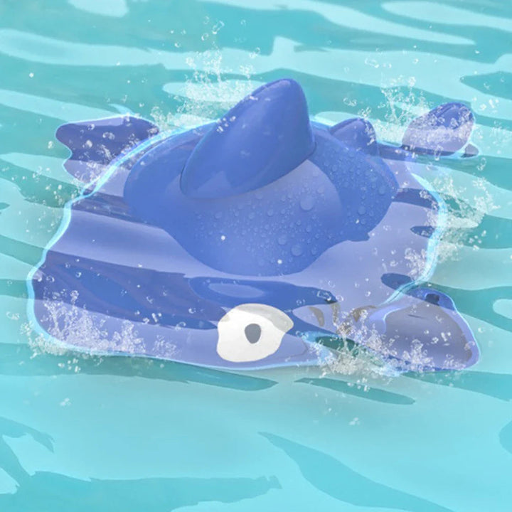 Blue sea-animal bath toy in water with splashes around its rounded body