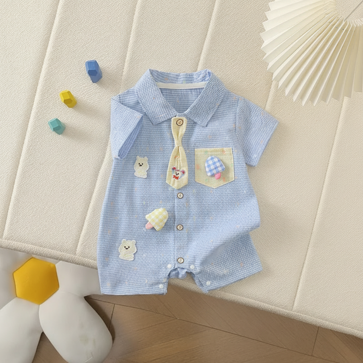 Blue collared baby romper laid flat with decorative tie and front snap closures