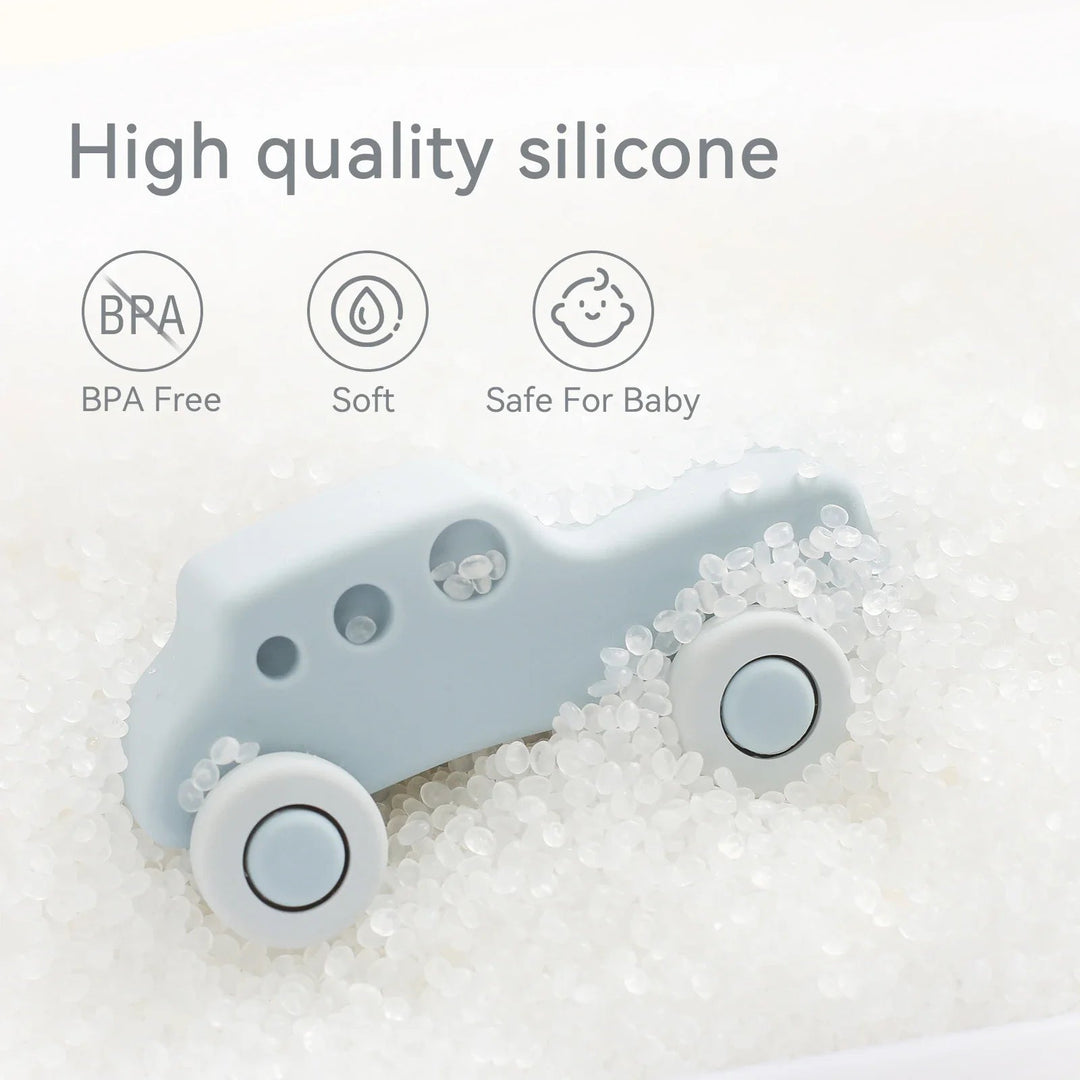 Light blue silicone toy car resting among clear beads