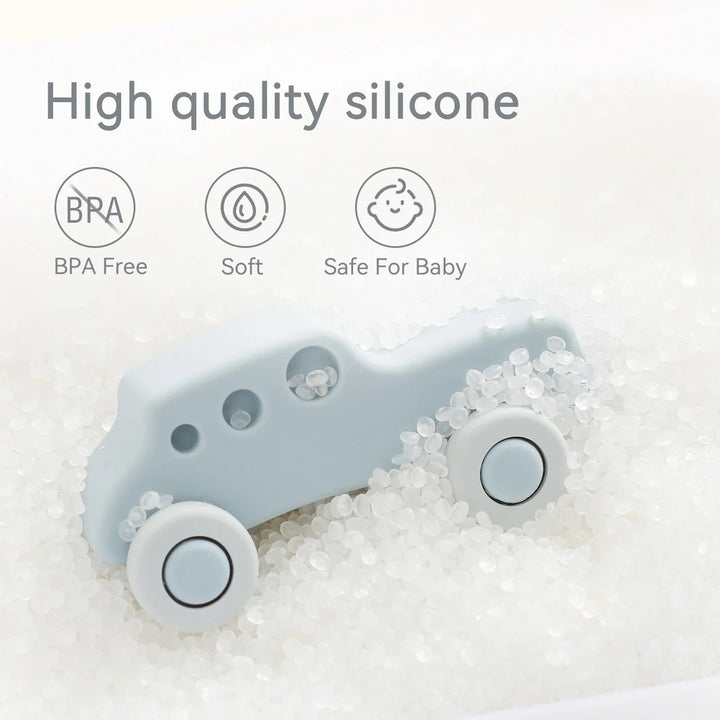Light blue silicone toy car resting among clear beads
