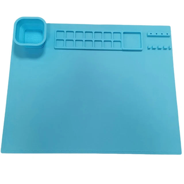 Blue silicone painting mat with a cup, paint wells, and brush holders.