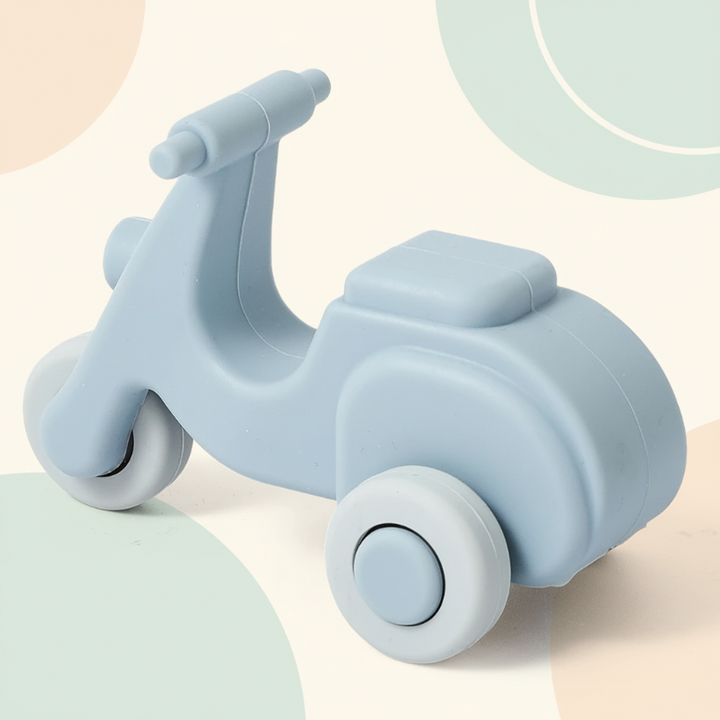 Blue silicone scooter teether with a raised seat and rounded wheels