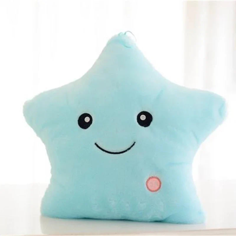 Blue plush star pillow with a smiling face and pink button