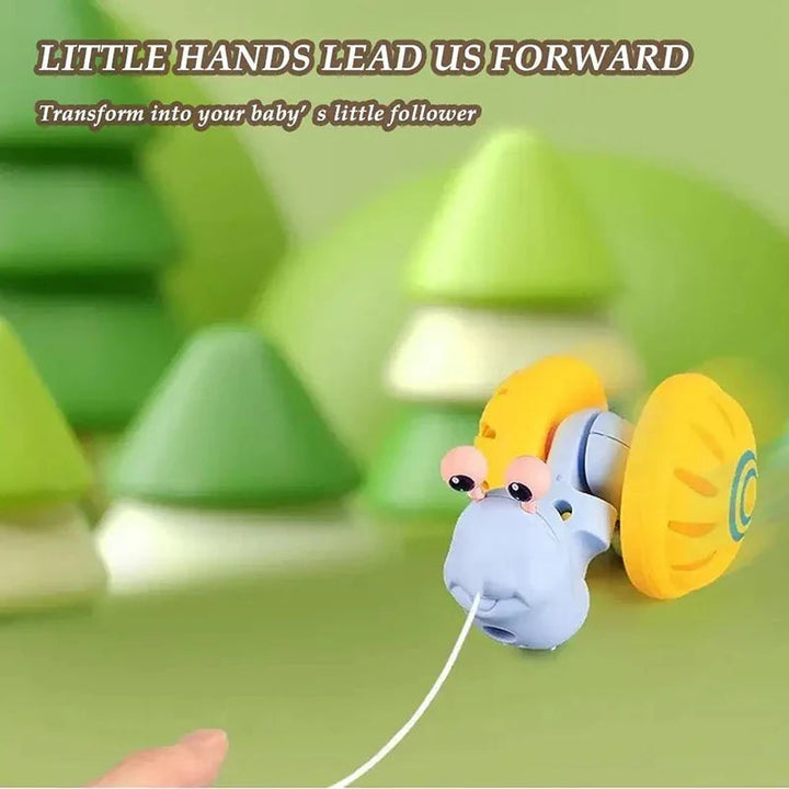 Blue snail with yellow shell-shaped wheels being pulled by a white cord
