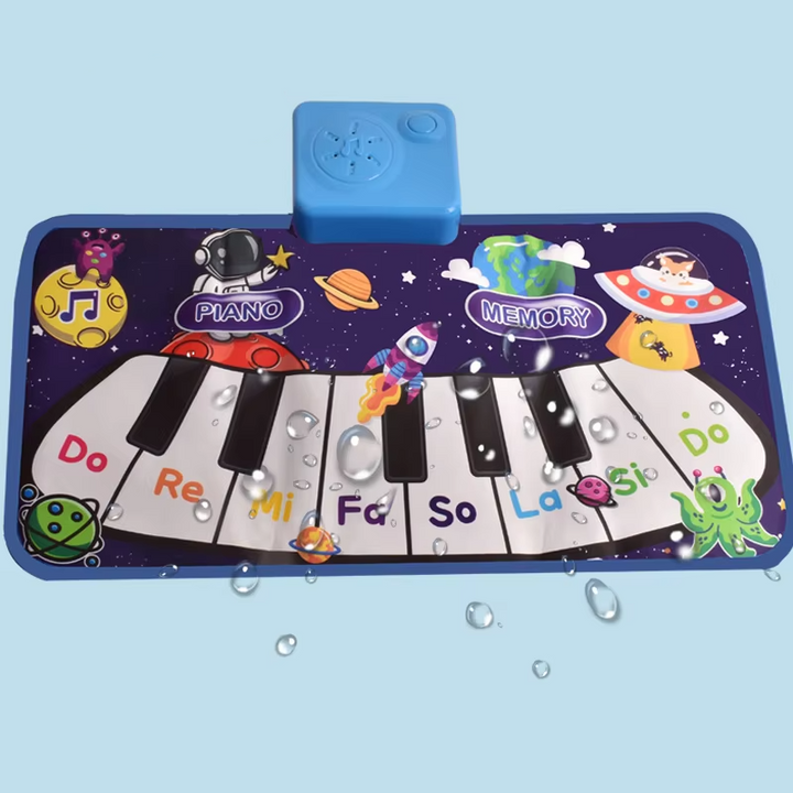 Blue space-themed piano play mat with note names and a sound module