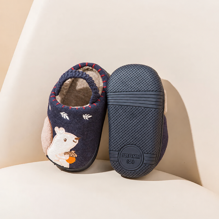 Blue squirrel slipper beside a matching slipper showing its textured rubber sole