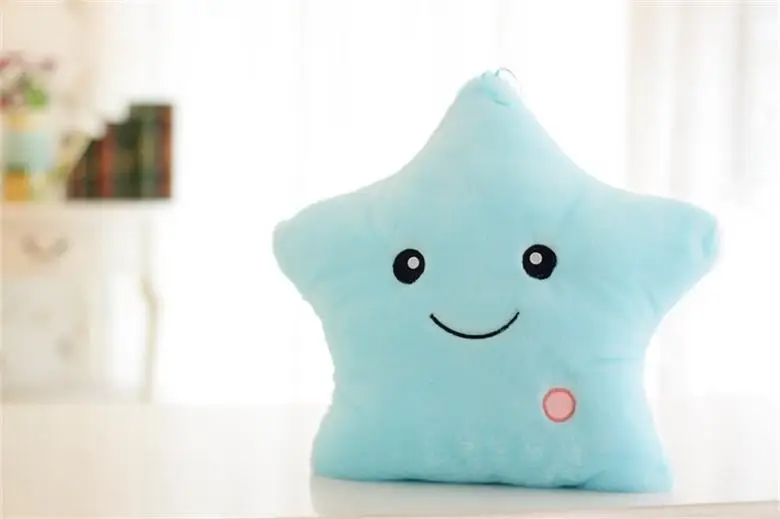 Blue star-shaped plush pillow with a smiling face and round pink button