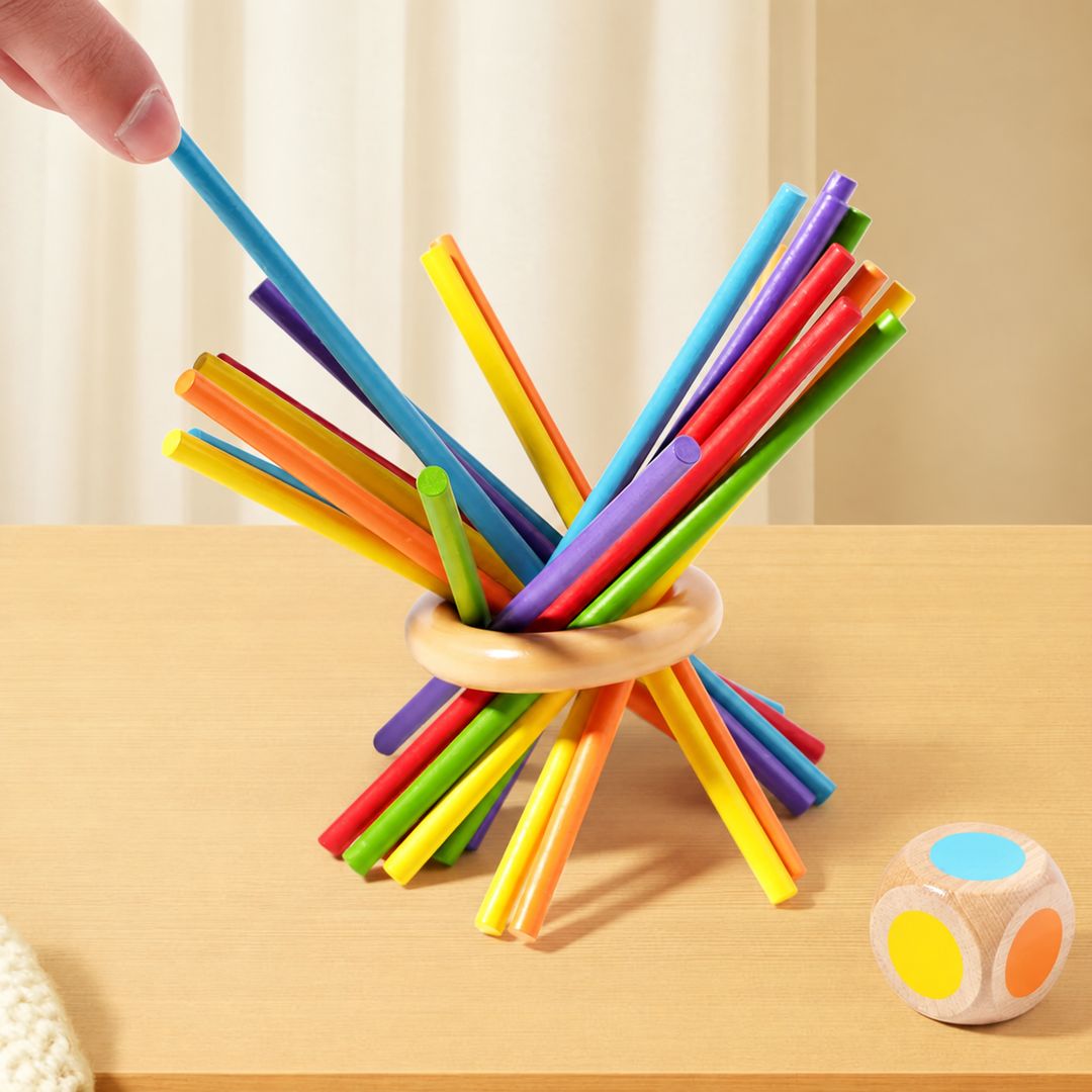 A hand lifting a blue stick from a colorful bundle balanced through a wooden ring.