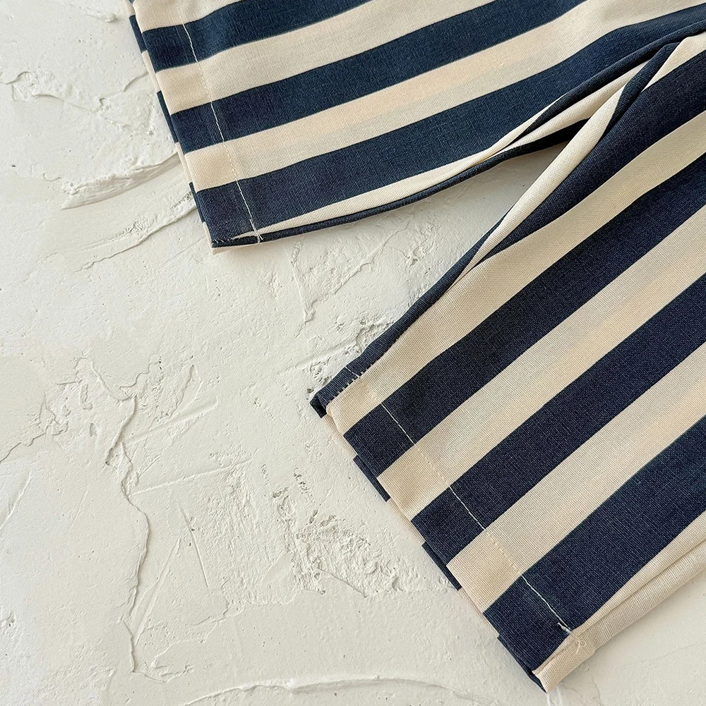 Blue and cream striped pant legs showing the straight hems