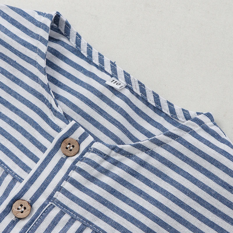 Round neckline and upper button placket on the blue striped shirt