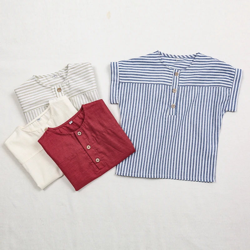 Blue striped shirt displayed beside folded gray striped, white, and red shirts