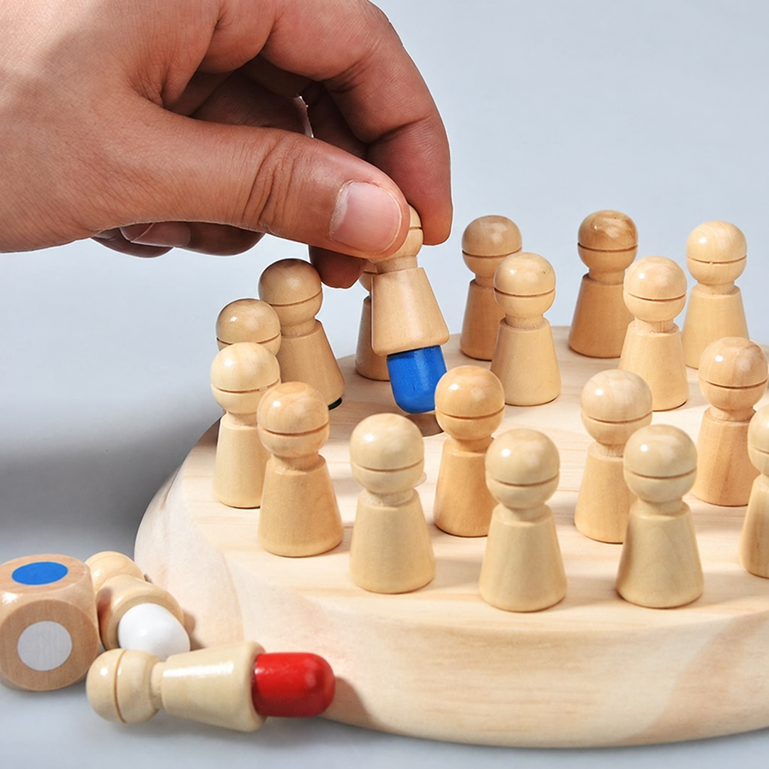 Hand lifting a wooden peg to reveal its blue end on the memory game board