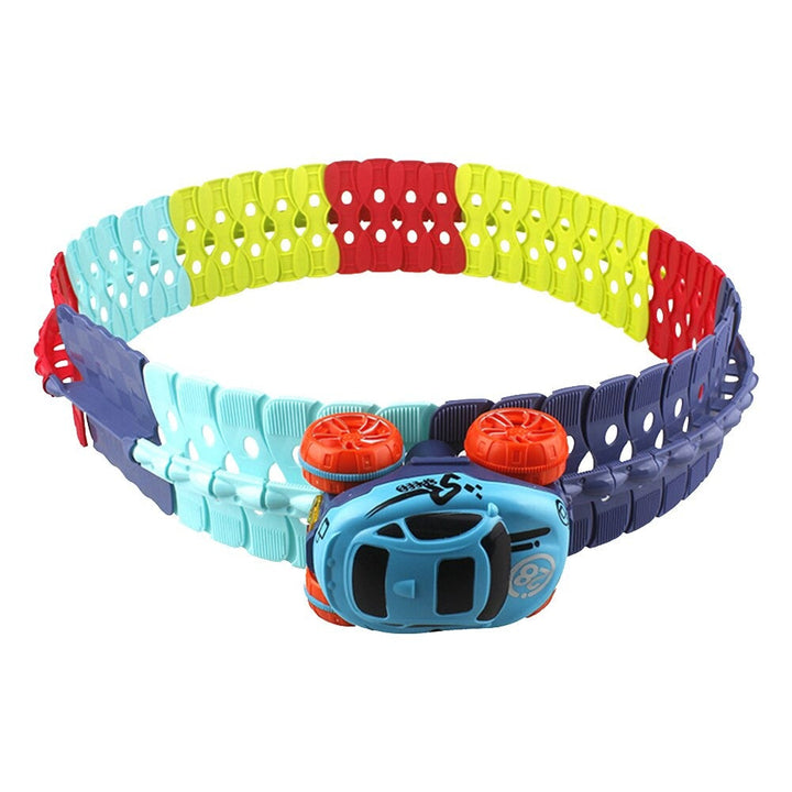 Blue toy car attached upside down to an upright ring of multicolor track