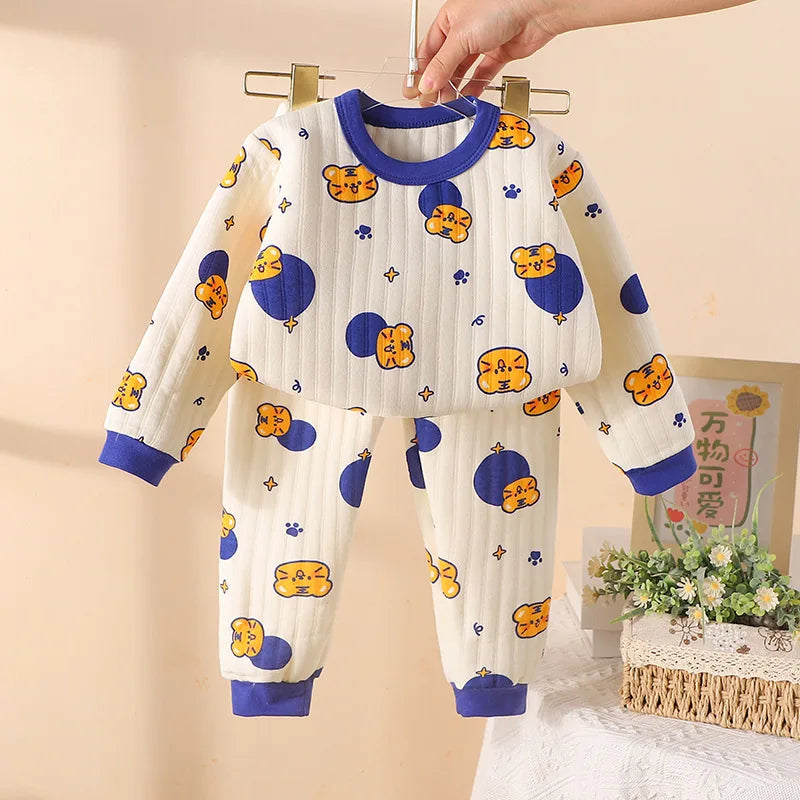 Blue-trimmed pajama set with a cream printed long-sleeve top and matching cuffed pants.