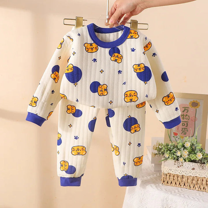 Blue-trimmed pajama set with a cream printed long-sleeve top and matching cuffed pants.