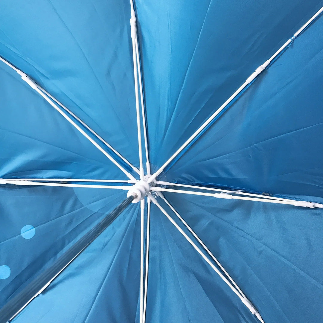 Inside a blue umbrella showing the canopy fabric, ribs, and center hub
