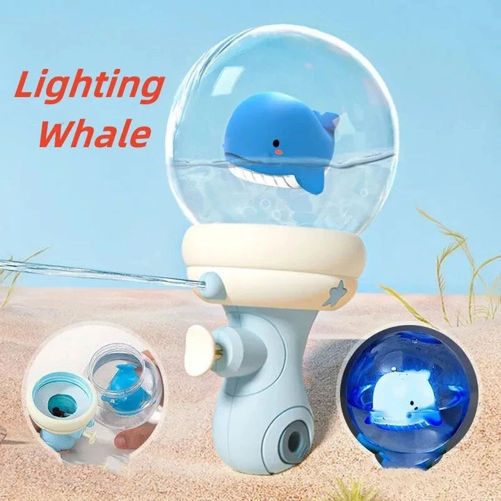 Blue whale water gun with a clear globe top and a blue-lit whale detail inset