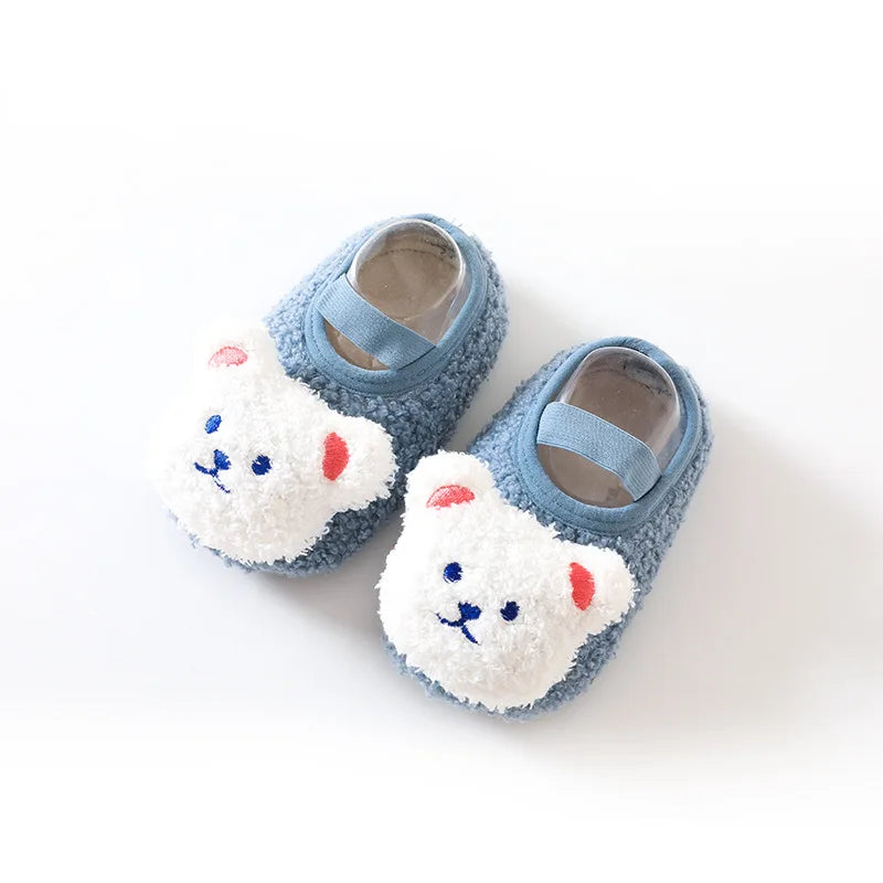 Pair of blue baby slippers with white bear faces and elastic bands
