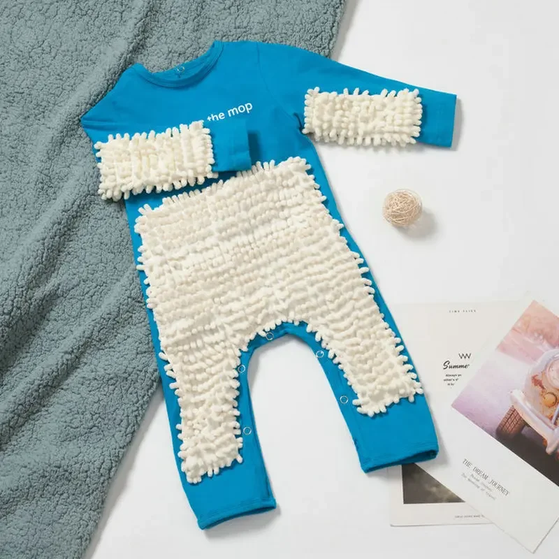 Blue baby jumpsuit with white cleaning fibers on the front and sleeves
