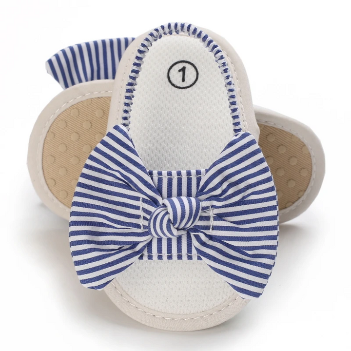 Blue-and-white striped bow baby sandals showing the footbed and textured sole