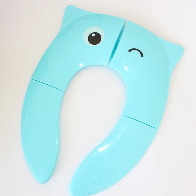 Blue folding toilet training seat with a winking animal face