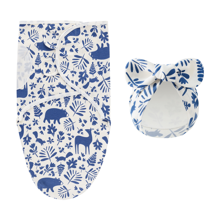 White swaddle blanket and matching bow hat with blue woodland animals and leaves