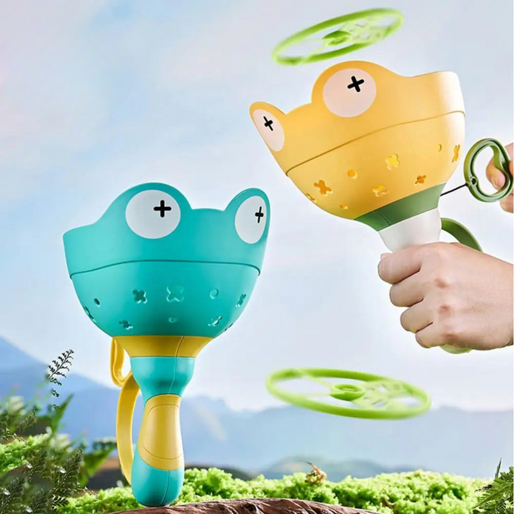 Blue and yellow frog-shaped disc launchers with green discs shown in flight