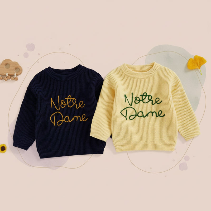 Navy blue and yellow children's sweaters with contrasting embroidered script, shown together.