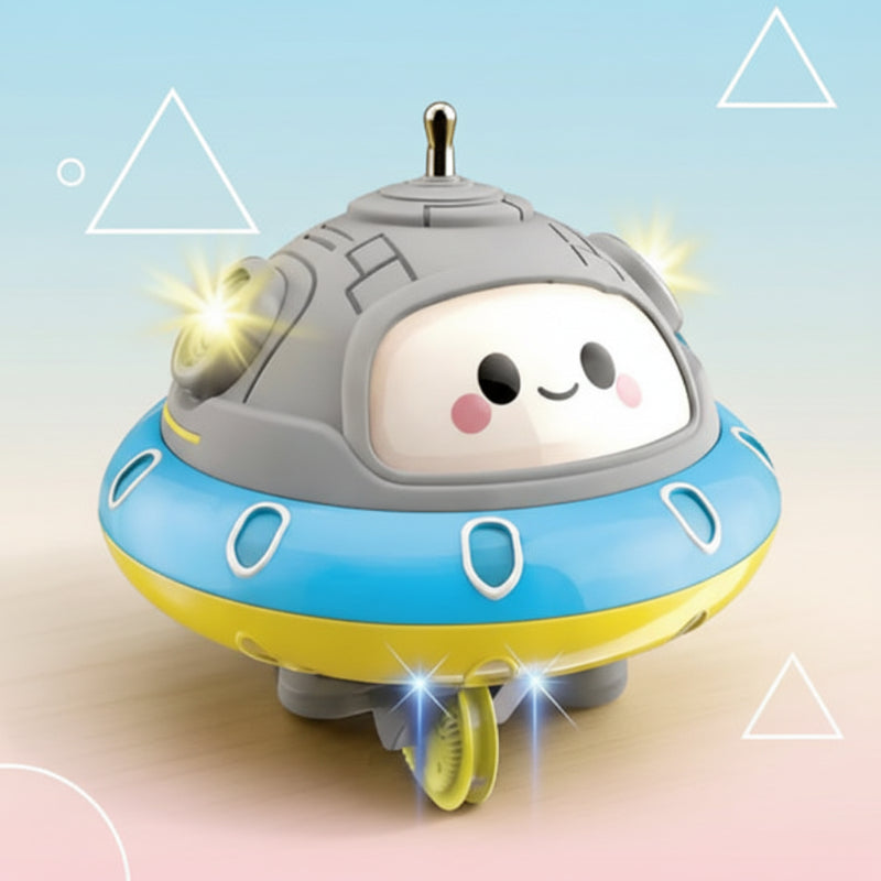 Close-up of the UFO balance toy with a smiling face, blue ring, yellow rim, and gray dome.