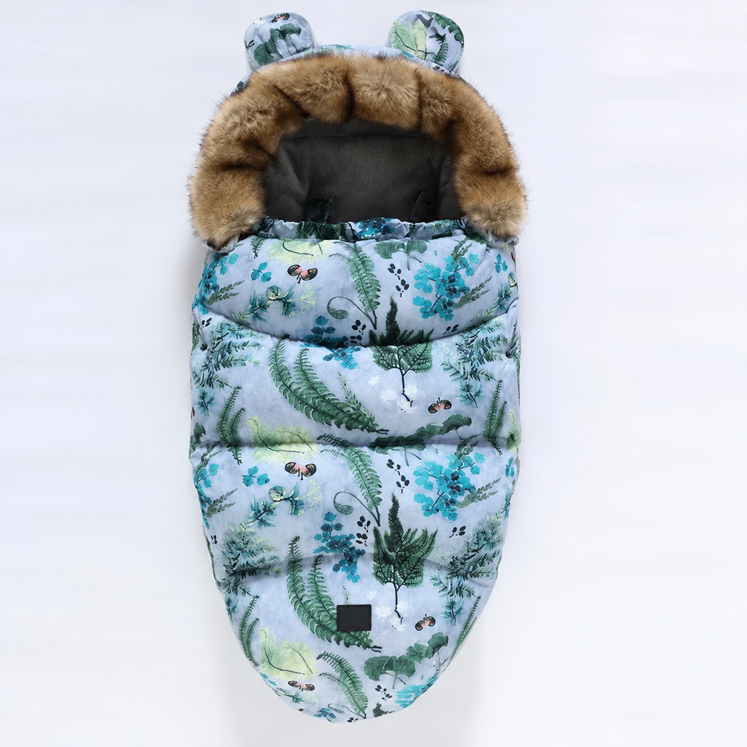 Botanical-print stroller footmuff with blue-green foliage and a faux fur collar