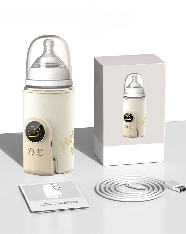 Cream-colored bottle warmer around a feeding bottle, beside its box, USB cable and instruction booklet