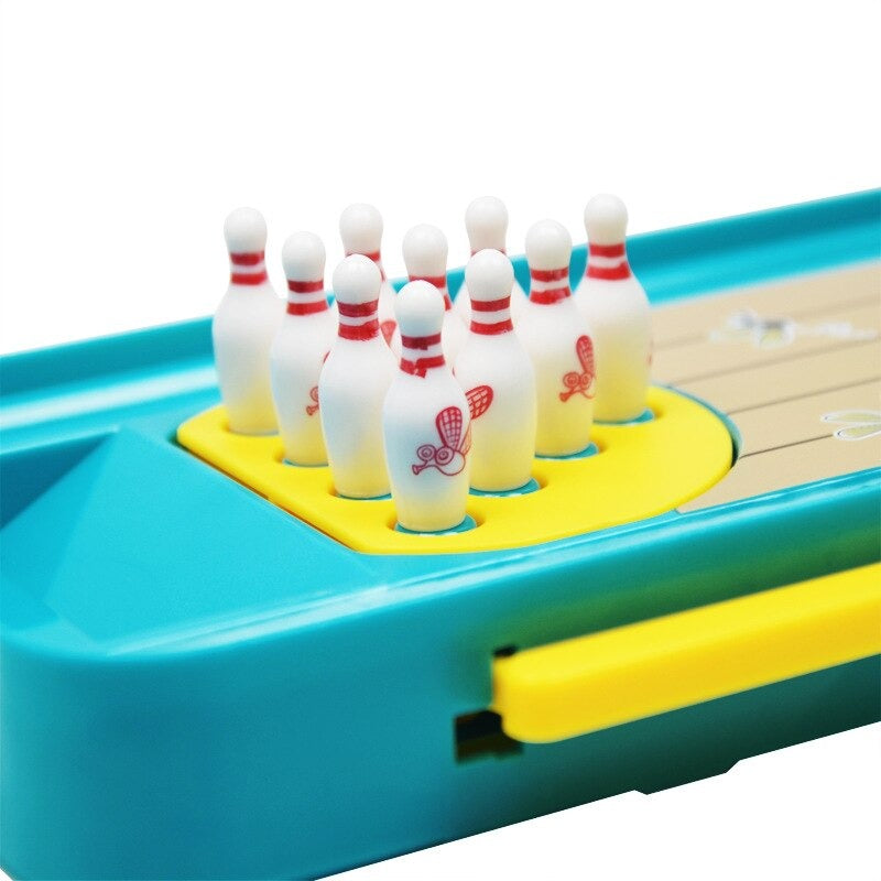 Close-up of white bowling pins on the yellow holder beside the lane&