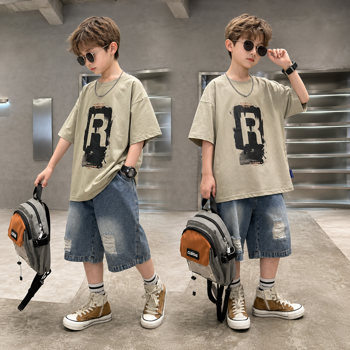 Two boys modeling beige R-graphic T-shirts with distressed blue denim shorts.