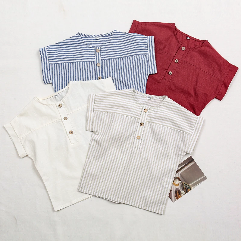 Four boys' short-sleeve shirts in blue stripes, gray stripes, white, and red arranged flat