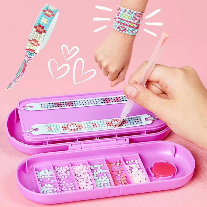 Hand placing a gem on a bracelet in an open pink craft case