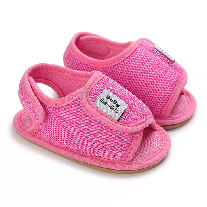 Bright pink mesh baby sandals with open toes and heel loops
