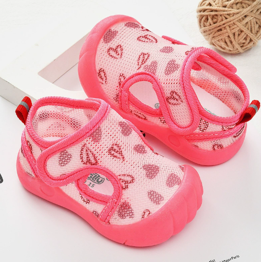 Bright pink mesh sandals with heart prints, pink toe caps and matching soles