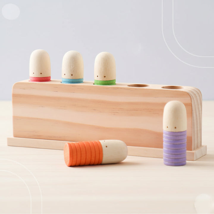 Bright wooden peg toy with three pegs in the base and two beside it